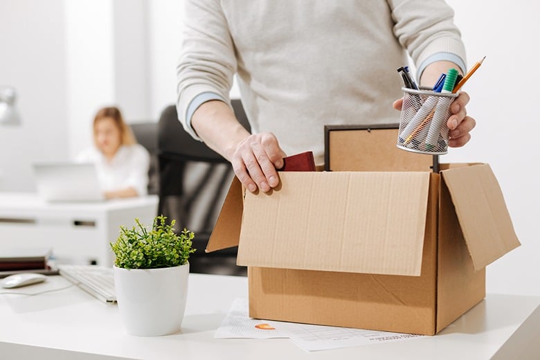 employee packing up desk after being fired