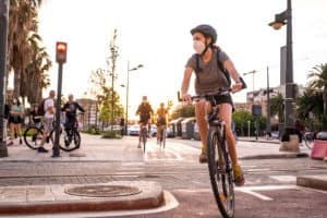 people riding bicycles with masks on