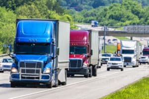 trucks-driving-on-highway-with-cars