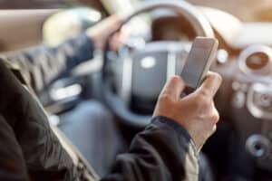 man-on-smartphone-texting-while-driving-car